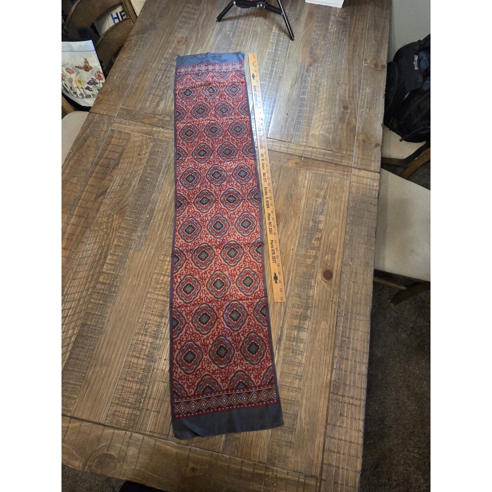 This 100% silk scarf is from Specialty House and features a black label